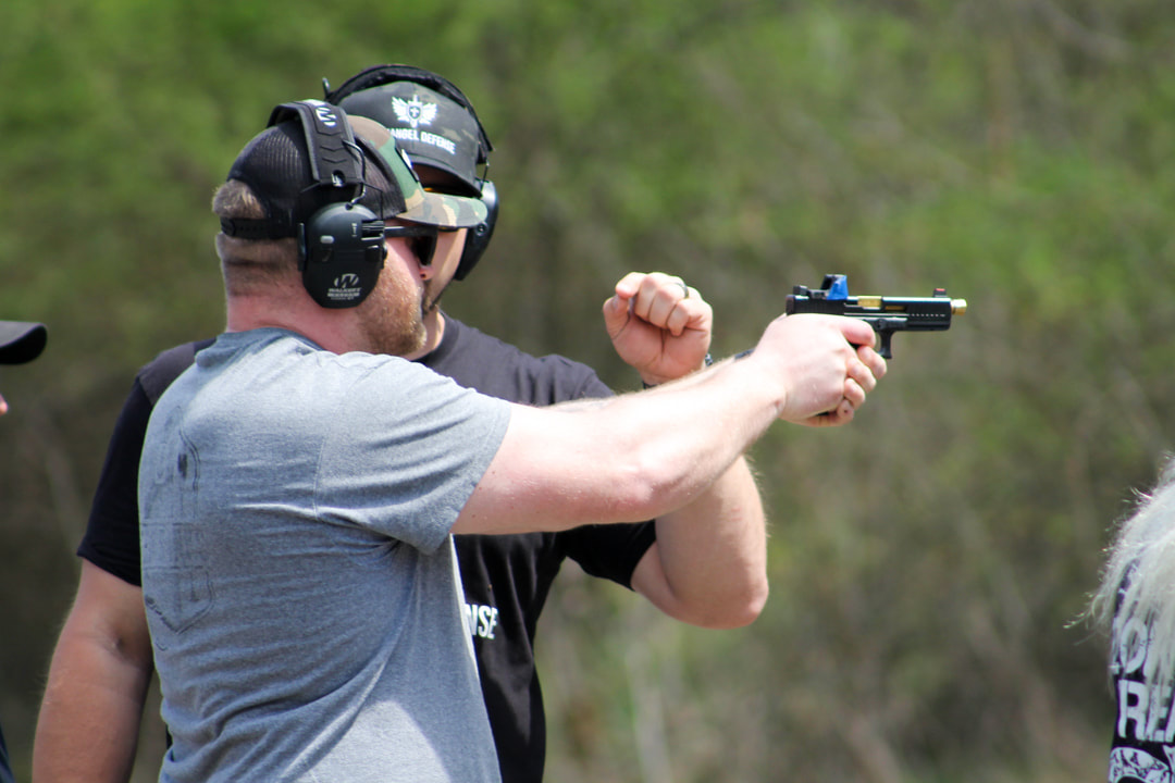 Kerry Dugan Jr. training a student at Archangel Defense in defensive firearms training